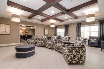 Common area with patterned chairs and modern decor