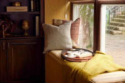 Cozy reading nook with cushions and a tray