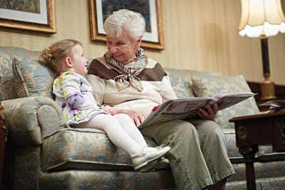 Resident and child engaging on a couch