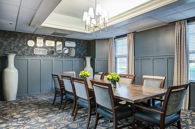 Dining room with a large table and floral centerpiece
