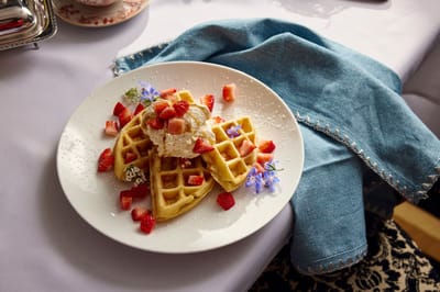 Delicious waffles topped with strawberries and cream