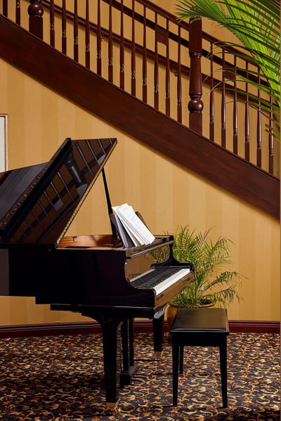 Black grand piano in a tastefully decorated lobby area