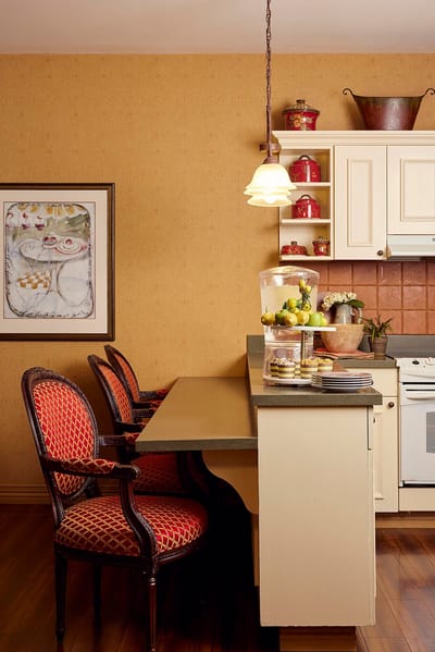 A bright kitchen area with fruit and seating