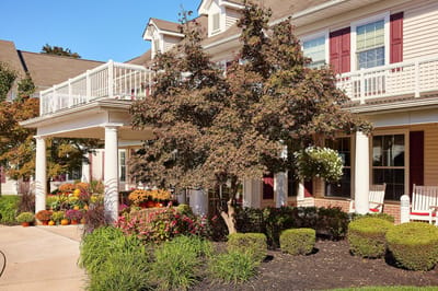 Exterior view of a senior living facility with landscaped area