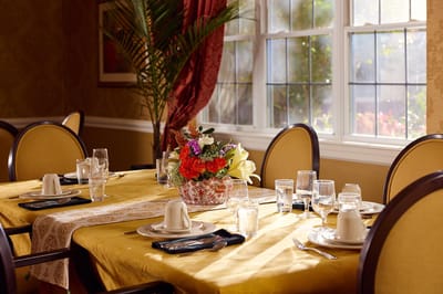 Beautifully set dining table with flowers and tableware