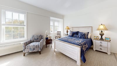 Cozy bedroom in a senior living facility with light decor