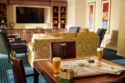 Common area with card game setup and drinks