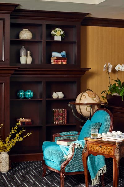 Cozy corner with blue chair and decorative shelves