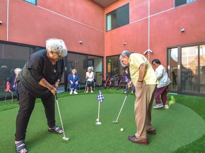 Residents enjoying a putting activity in the courtyard