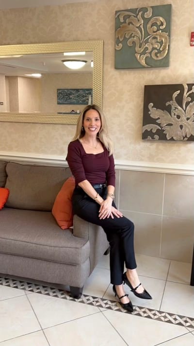 Staff member posing in the facility's common area