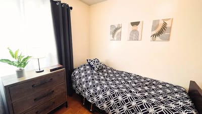 A neatly arranged private resident room with decor