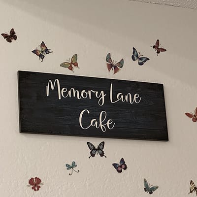 Sign for the Memory Lane Cafe with butterfly decorations