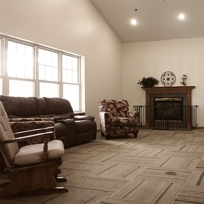 A cozy common area with seating and a fireplace.