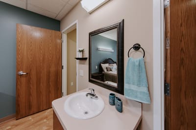 Facility interior with a bathroom and bedroom view