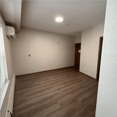 Empty interior room with wooden flooring
