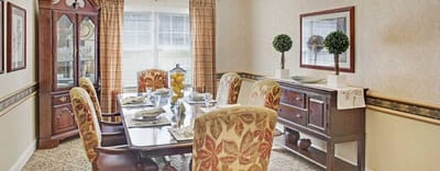 Elegant dining room with decorative seating and table settings