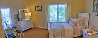 Cozy private resident room with a bed and seating area