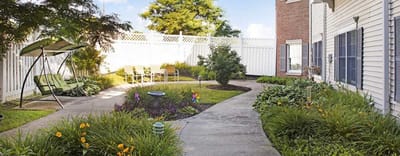 Well-maintained garden area with seating in a senior living facility