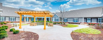 Outdoor space with a pergola and landscaped area
