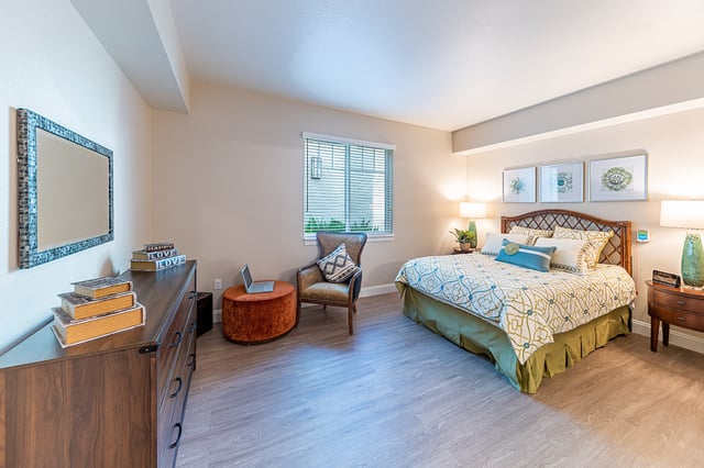 Well-furnished resident room with a bed and decorative accents