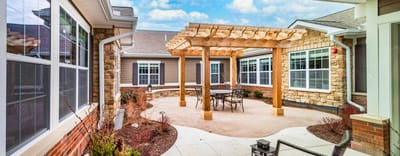 Outdoor patio area with seating and decorative structure