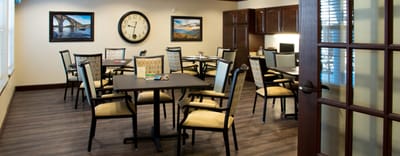 Bright common area with dining tables and chairs