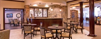 Common area with seating and decor in a senior living facility