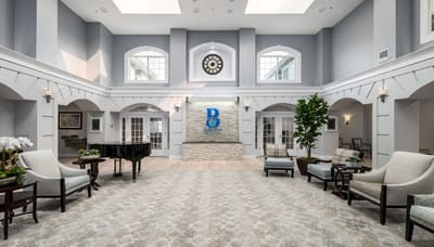 Spacious interior with seating and piano in common area
