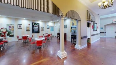 Interior view of a dining room with red chairs