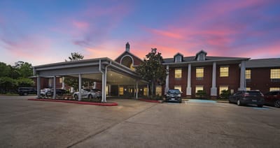 Entrance of Collier Park Senior Living at sunset