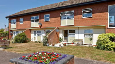 Exterior view of the assisted living facility with flower beds