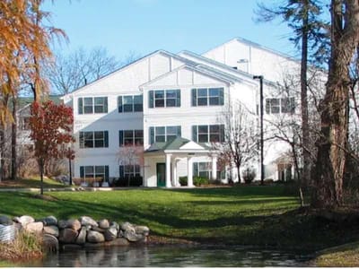 Exterior view of a senior living facility with greenery