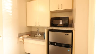 Interior kitchenette area with microwave and fridge