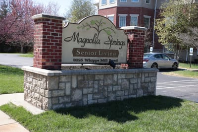 Sign for Magnolia Springs Senior Living outside the building
