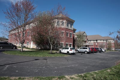 Exterior view of Magnolia Springs Louisville with trees and parking area