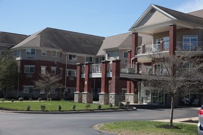 Exterior view of a senior living facility with landscaped entry