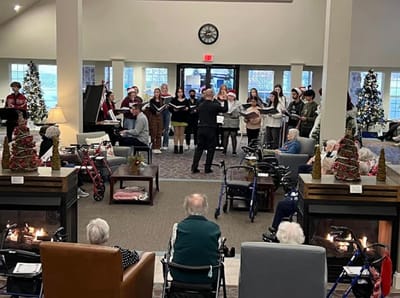 Residents enjoying a musical performance in a common area