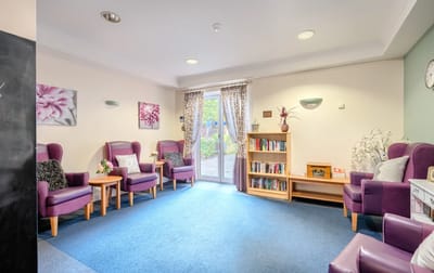 Bright common area with seating and bookshelves