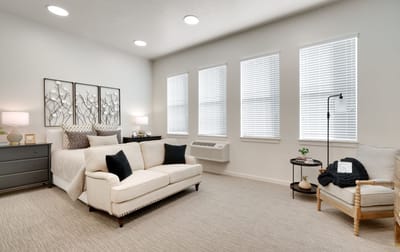 Bright interior of a private resident room with a sofa