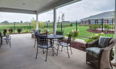 Patio seating area with view of grassy landscape