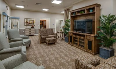 Bright common area with comfortable seating and a TV