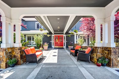 Covered entrance area with orange and black seating