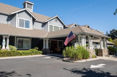 Front exterior of Aegis Living Pleasant Hill with American flag