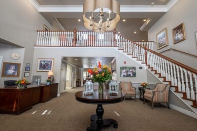 A spacious lobby area with seating and floral arrangements