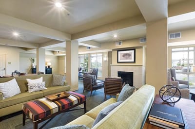 Bright common area with comfortable seating in a senior living facility