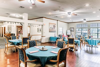 Bright dining area with teal tables and decorations