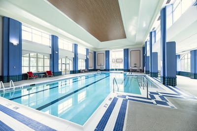 Indoor swimming pool area with lounging chairs