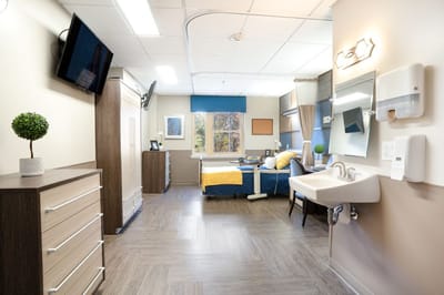 Bright private room with bed and furniture