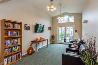 Bright common area with seating and bookshelves