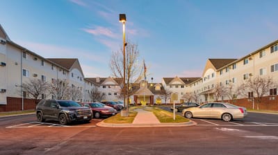 Exterior view of Amira Choice Champlin with parking lot
